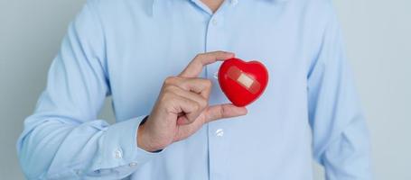 man hand holding red heart shape. love, donor, world heart day, world health day and Insurance concepts photo