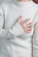 woman hand holding chest ache. Heart disease, angina disease and symptom heart attack disease Cardiovascular, Atherosclerosis, Hypertensive world Heart day and health concept photo