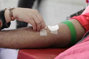 Blood donor in arm injection select focus with shallow depth of field. photo