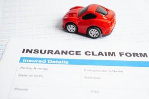 Stethoscope on Insurance claim accident car form, Car loan, insurance and leasing time concepts. photo