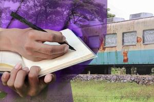 businessman  with notepad  hand signing documents in train repair double exposure concept . photo