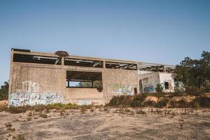 Abandoned warehouse with graffitis photo