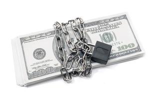 Lock security and chain on dollar stack banknotes isolated on white background. Monetary crisis, financial problems, default concept photo
