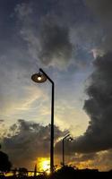 silhouette of lights against a background of clouds and sunset photo