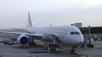 Abu Dhabi Airport terminal with passengers and plane video