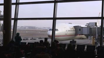 Abu Dhabi Airport terminal with passengers and plane video