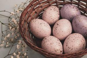 Pastel Easter eggs background. Spring greating card. Easter eggs in basket photo