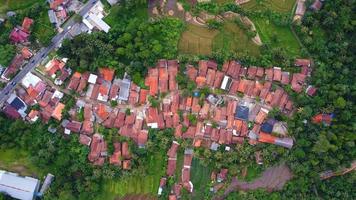 Drone photos from above view of beautiful village houses. Surrounded by lots of trees and close to the main road