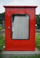 A red fire hydrant box, in the afternoon in the garden courtyard in the istiqlal mosque area photo