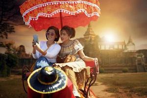 couples asian woman riding on elephant against beautiful old temple in ayutthaya world heritage site of unesco central of thailand photo