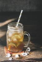 ice lemon tea in the glass with lime slices photo