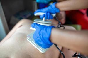 Paramedics using Defibrillator AED  in conducting a basic cardiopulmonary resuscitation. photo