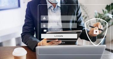 Cyber security concept, Login, User, identification information security and encryption, secure access to user's personal information man using smart phone and tablet in office photo