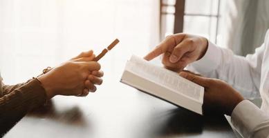 Woman's hand with cross .Concept of hope, faith, christianity, religion, church and pray to God. on the table photo