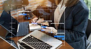 Project manager working and update tasks with milestones progress planning and Gantt chart scheduling diagram. business working with smart phone, tablet and laptop in office. photo