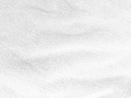 White clean wool texture background. light natural sheep wool. white seamless cotton. texture of fluffy fur for designers. close-up fragment white wool carpet. photo