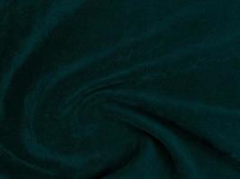 Dark green old velvet fabric texture used as background. Empty green fabric background of soft and smooth textile material. There is space for text. photo