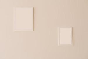 White mockup frames on a beige wall of different sizes photo