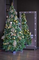 Christmas tree on a brown background in an interior photo studio.