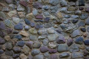 Background wall from large multi-colored stones boulders. photo