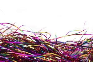 Festive background. Lots of multicolored tinsel close-up on a white background. photo