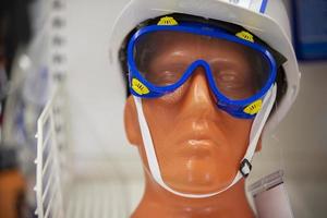 Close-up of the face of a plastic mannequin wearing goggles. photo