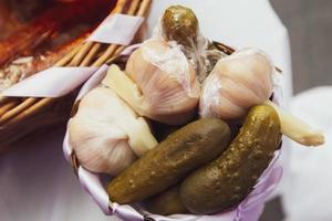 Pickled cucumbers and garlic on a plate. Canned vegetables. photo