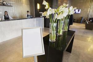 The lobby of the hotel is decorated with vases with flowers. photo