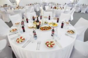 Blurred image of a table set with food. photo