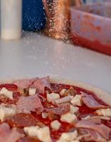 Sprinkling grated parmasan photo