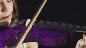 Close-up of musician woman playing violin at home. Composing, playing music. Positive musician woman plays the violin at home and is in a good mood. video