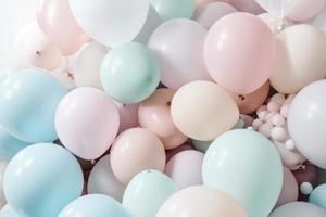 Pastel colorful balloons in white room background. Party and celebration. photo