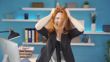 Business woman pulling her hair out of anger in the office. The beautiful woman pulls her hair out of anger when things go wrong in the office. video