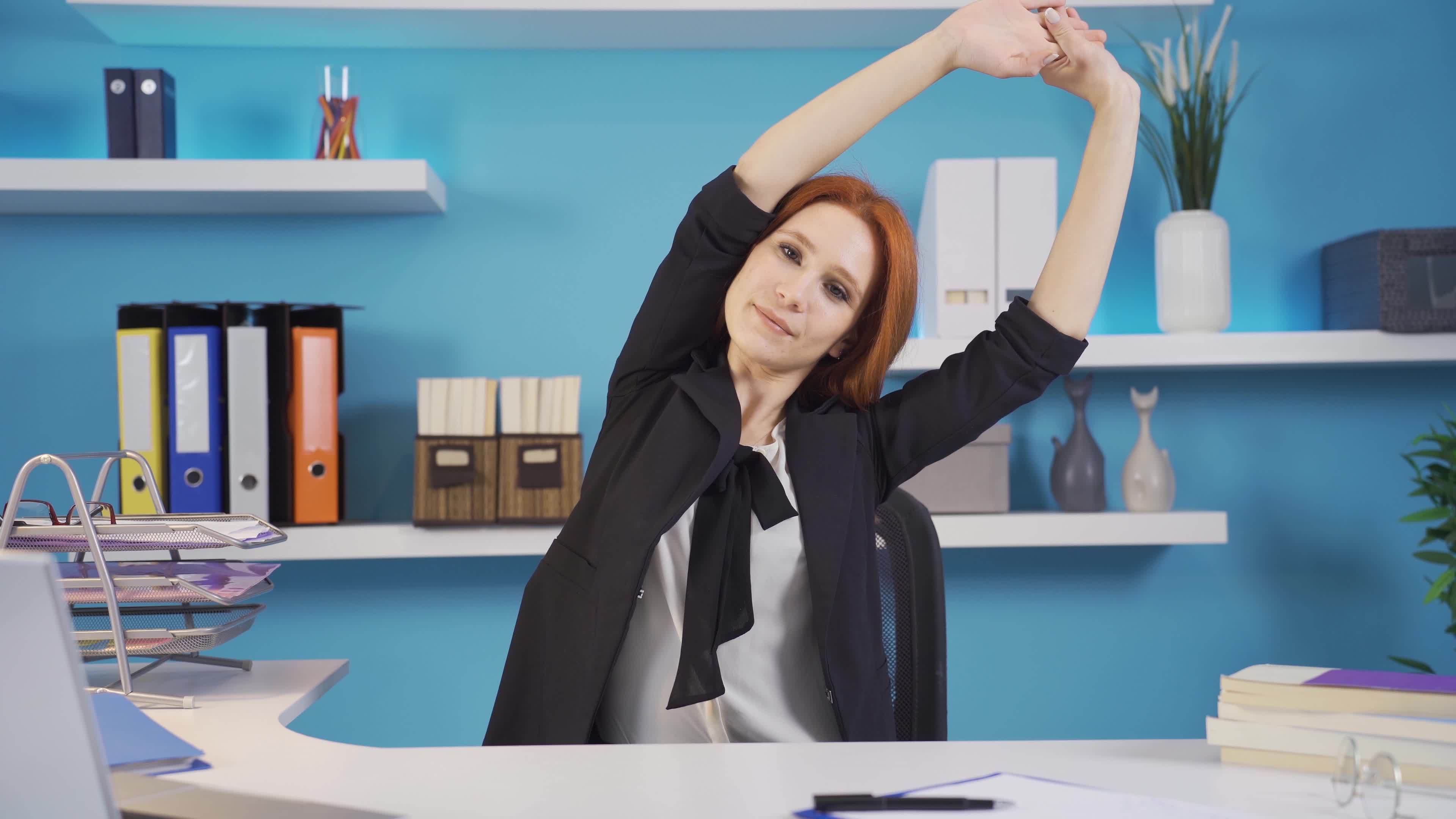Exercises that can be done in the office. Arm exercises. Business woman doing arm exercises in