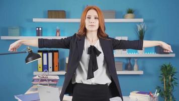 Exercises that can be done in the office. Business woman doing standing wrist exercise. Woman doing wrist exercise with arms raised in office. video