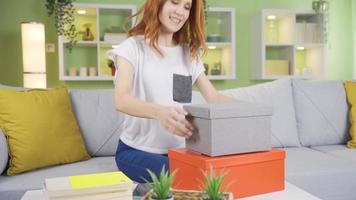 Smiling cheerful young woman opening gift boxes. Happy young woman receiving birthday present, valentine present opens gift packages and rejoices. video