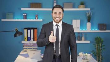 homem de negocios sorridente às Câmera fazer positivo placa. homem de negocios fazer Está bem placa com mão enquanto olhando às Câmera dentro escritório. video