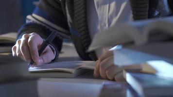 Young researcher man reading book in modern study room. Young wise man with glasses reading a book in his room. video