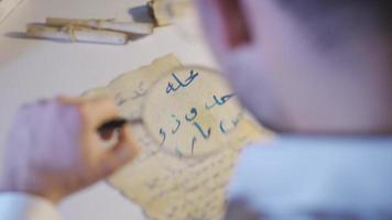 The inscription scientist examines the medieval correspondence letter. Epigraphist examining a letter written for communication in the Middle Ages. video