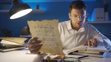 Historian examining the medieval letter. Epigraphist examining and researching a medieval handwritten letter. video