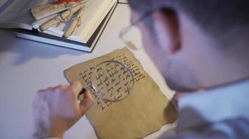 Historian who studies the historical letter written in the medieval alphabet. The inscription scientist is investigating the letter that was written in the middle ages. video