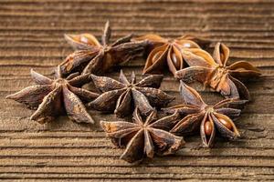 Dried star anise spice on vintage wooden board photo