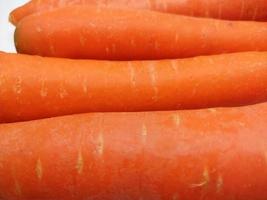 Heap of fresh carrots isolated on white background. photo