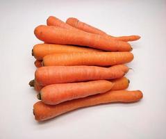 Heap of fresh carrots isolated on white background. photo