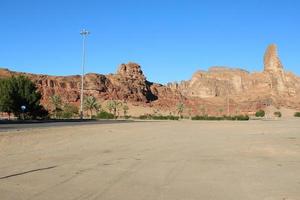 A beautiful daytime view of a winter park in Al Ula, Saudi Arabia. The park is surrounded by ancient hills. photo
