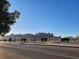 A beautiful daytime view of a winter park in Al Ula, Saudi Arabia. The park is surrounded by ancient hills. photo