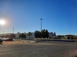 A beautiful daytime view of a winter park in Al Ula, Saudi Arabia. The park is surrounded by ancient hills. photo