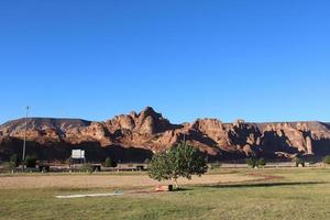 A beautiful daytime view of a winter park in Al Ula, Saudi Arabia. The park is surrounded by ancient hills. photo