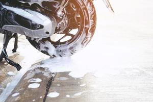 The worker is washing the motorcycle at Car Care. photo