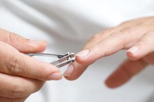 Clean and cut dirty nails to prevent germs and bacteria. photo